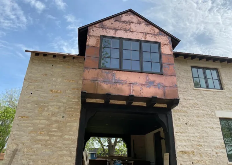 Copper metal panel facade on a stone building for Roof Repair in River Forest