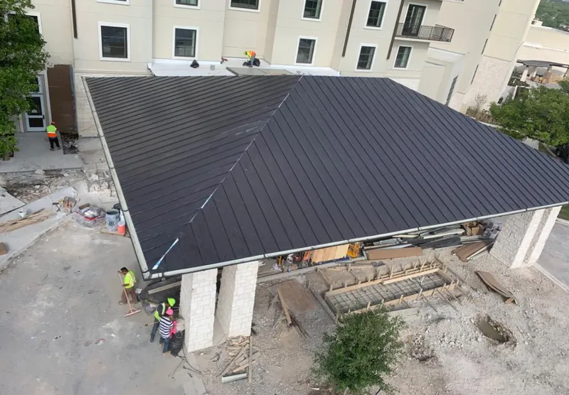 Metal roofing installation team working on a commercial building in River Forest