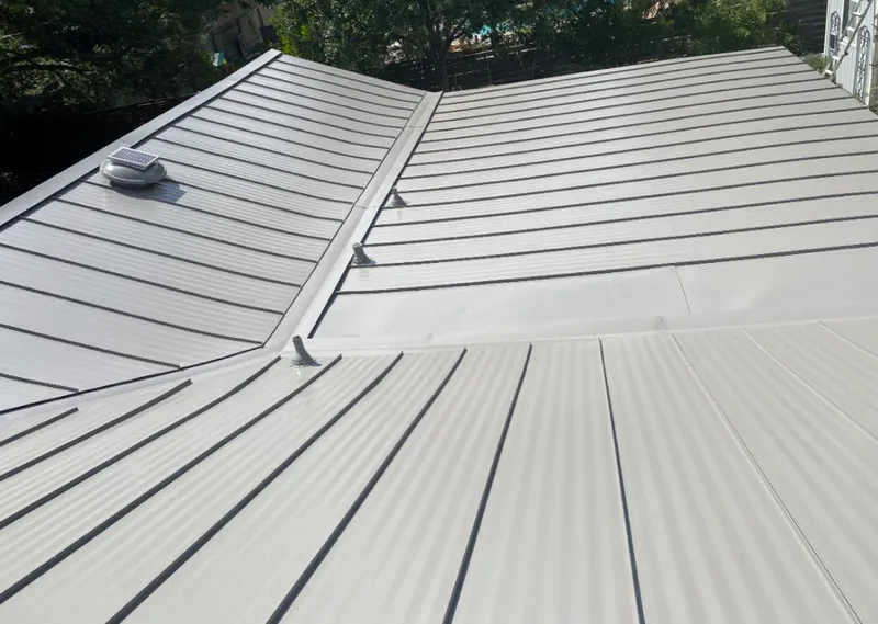 Solar attic fan installed on a metal roof for Roof Ventilation in River Forest
